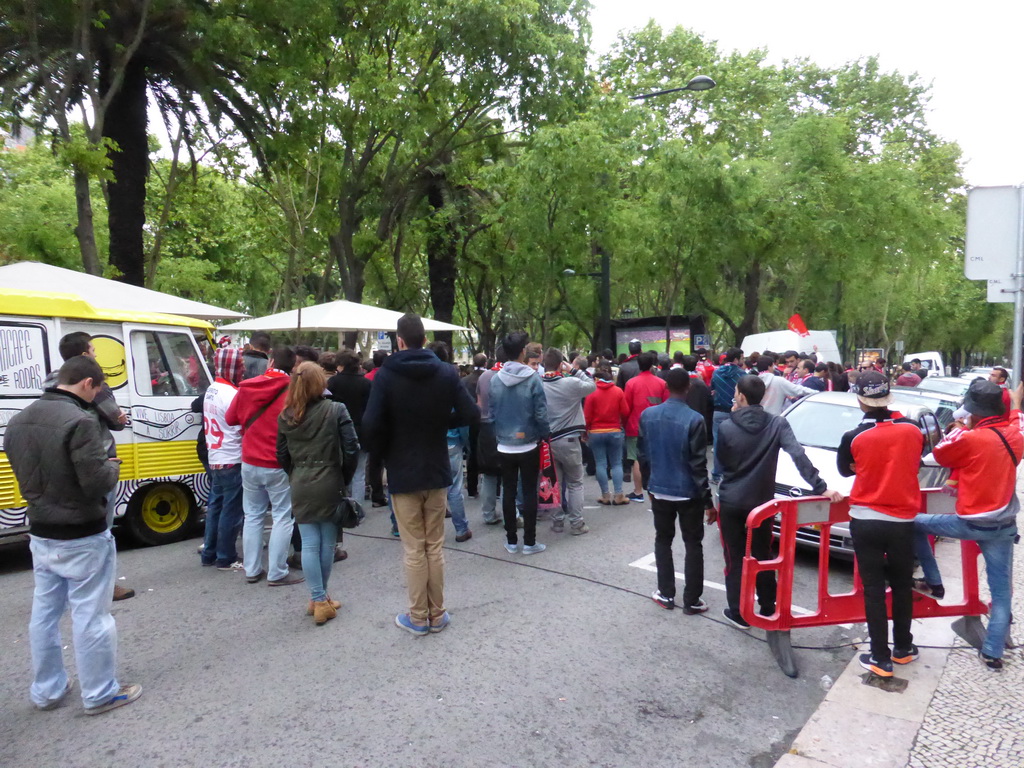 Fans of the S.L. Benfica soccer team watching the championship game on a screen at the Avenida da Liberdade avenue