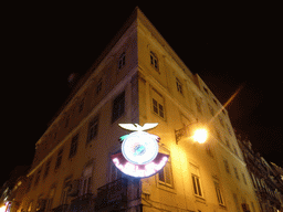 The logo of the S.L. Benfica soccer club on a building at the Rua das Portas de Santo Antão street, by night