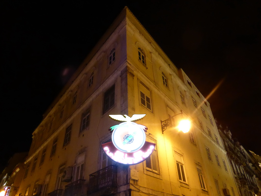 The logo of the S.L. Benfica soccer club on a building at the Rua das Portas de Santo Antão street, by night