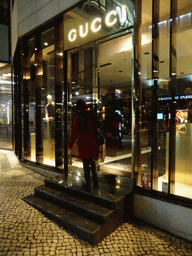 Miaomiao in front of the Gucci store at the Tivoli Forum shopping mall at the Avenida da Liberdade avenue, by night