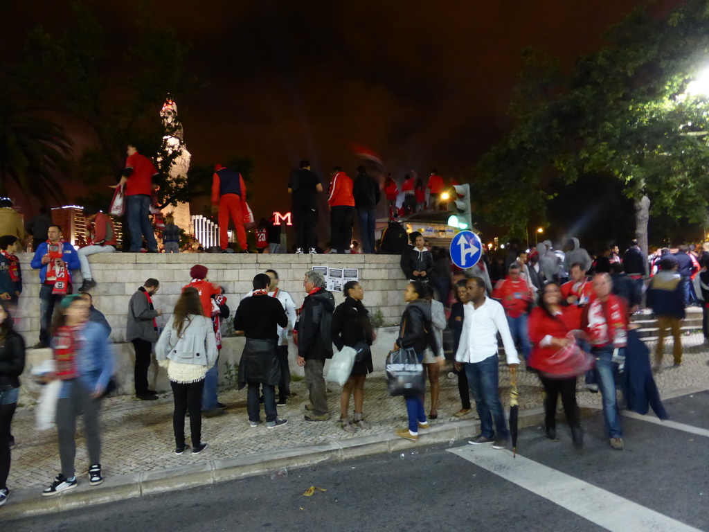 Fans of the S.L. Benfica soccer team celebrating the championship and the statue of the Marquess of Pombal at the Praça do Marquês de Pombal square, by night