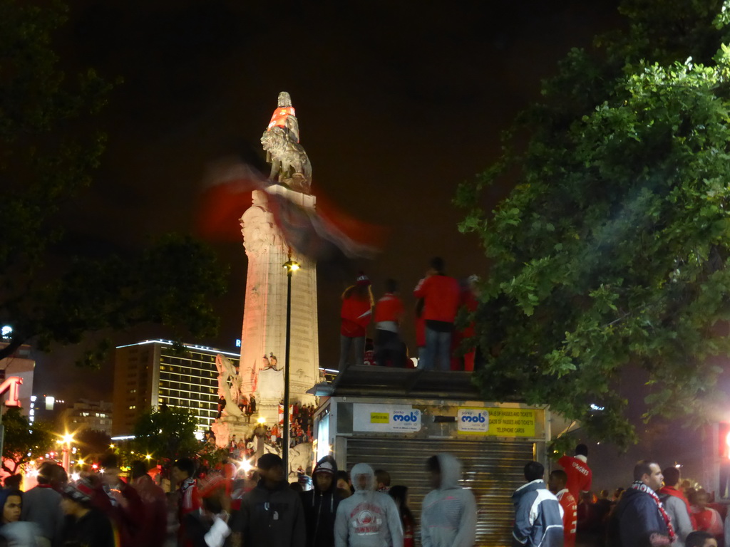 Fans of the S.L. Benfica soccer team celebrating the championship and the statue of the Marquess of Pombal at the Praça do Marquês de Pombal square, by night