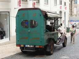 Old automobile playing fado music at the Rua do Carmo street