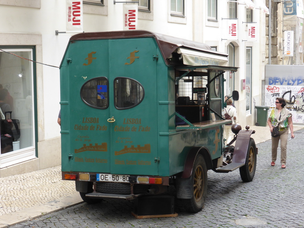 Old automobile playing fado music at the Rua do Carmo street