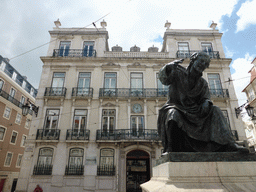 Statue of António Ribeiro in front of an office building at the Largo do Chiado square