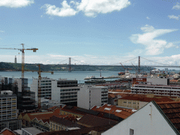 The Ponte 25 de Abril bridge over the Rio Tejo river and the Cristo Rei statue, viewed from the Miradouro da Santa Catarina viewpoint