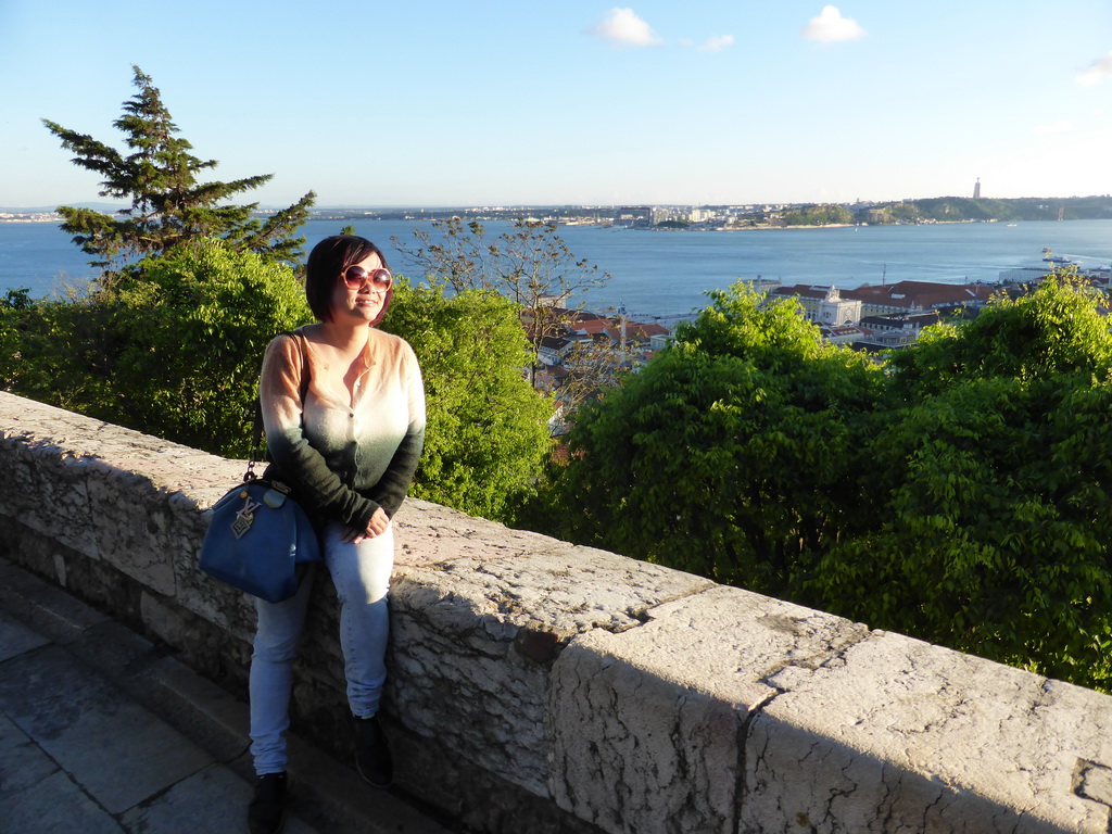 Miaomiao at the Praça d`Armas square at the São Jorge Castle, with a view on the Rio Tejo river and the Cristo Rei statue