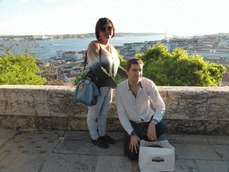 Tim and Miaomiao at the Praça d`Armas square at the São Jorge Castle, with a view on the Ponte 25 de Abril bridge over the Rio Tejo river and the Cristo Rei statue