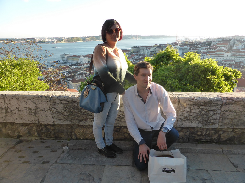 Tim and Miaomiao at the Praça d`Armas square at the São Jorge Castle, with a view on the Ponte 25 de Abril bridge over the Rio Tejo river and the Cristo Rei statue