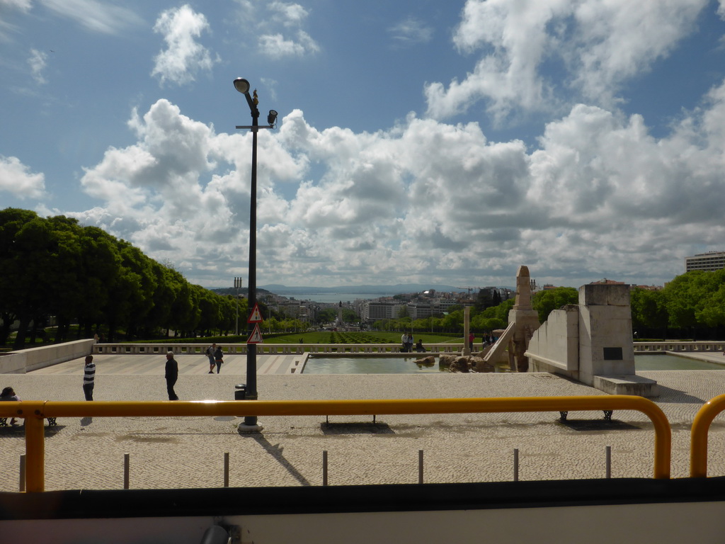 Fountain at the Parque Eduardo VII park and the Praça do Marquês de Pombal square with the statue of the Marquess of Pombal, viewed from the sightseeing bus at the Alameda Cardeal Cerejeira street