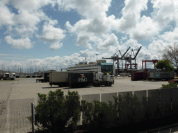 Trucks and boats at the Doca de Alcântara dock, viewed from the sightseeing bus
