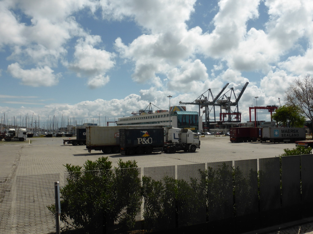 Trucks and boats at the Doca de Alcântara dock, viewed from the sightseeing bus