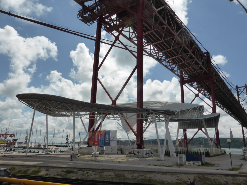 Stage under the Ponte 25 de Abril bridge over the Rio Tejo river and the Cristo Rei statue, viewed from the sightseeing bus