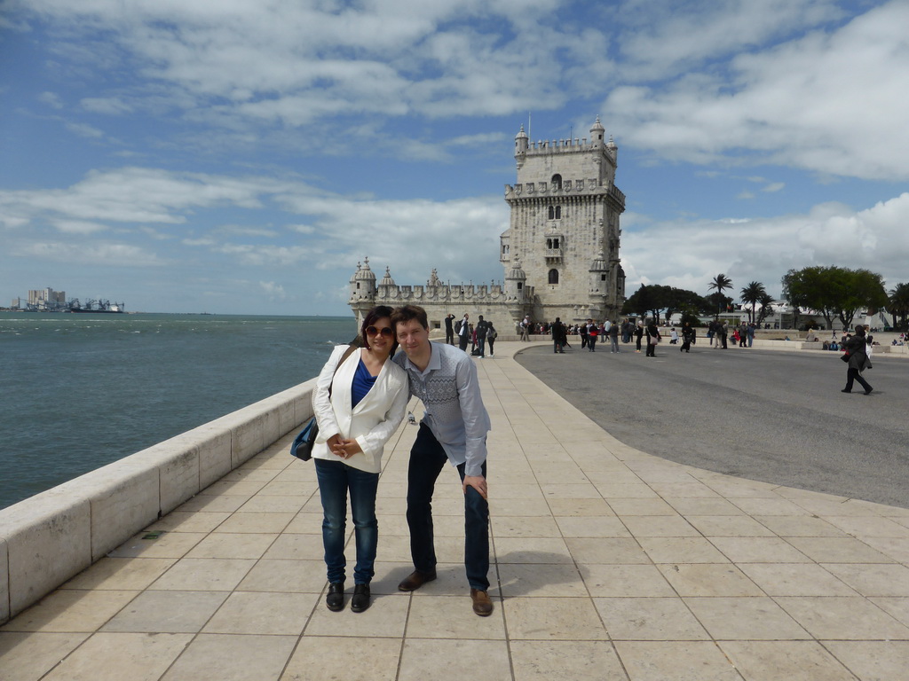 Tim and Miaomiao in front of the Torre de Belém tower and the Rio Tejo river