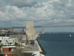 The coastline on the east side with the Padrão dos Descobrimentos monument and the Ponte 25 de Abril bridge over the Rio Tejo river, viewed from the fourth floor of the Torre de Belém tower