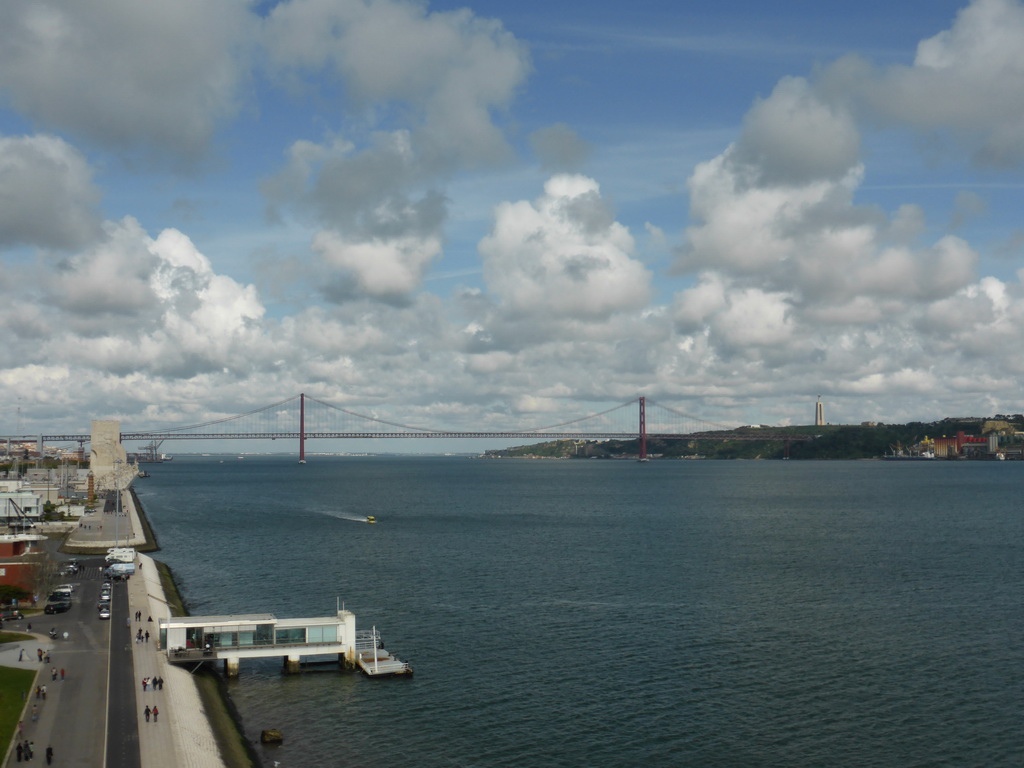 The coastline on the east side with the Padrão dos Descobrimentos monument, the Ponte 25 de Abril bridge over the Rio Tejo river and the Cristo Rei statue, viewed from the top of the Torre de Belém tower