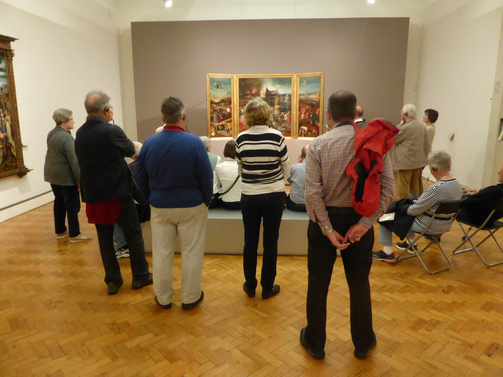 People looking at the triptych `The Temptations of St. Anthony` by Hieronymus Bosch, at the first floor of the Museu Nacional de Arte Antiga museum