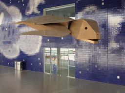 Wooden model of a sea turtle hanging over the main walkway at the Lisbon Oceanarium
