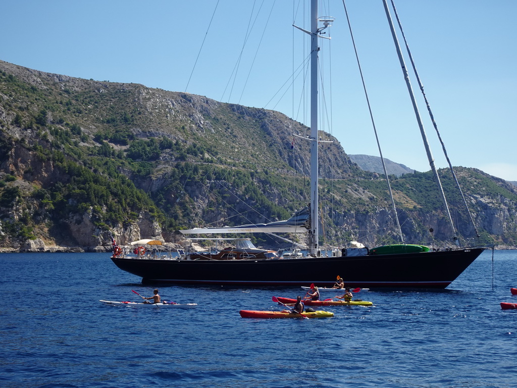 Boat and canoes in front of the east side of Dubrovnik, viewed from the ferry from Dubrovnik Harbour