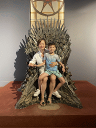 Miaomiao and Max on the Iron Throne from Game of Thrones at the Game of Thrones exhibition at the Lokrum Visitor Center at the southeast side of the Benedictine Monastery of St. Mary
