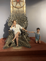 Miaomiao and Max on the Iron Throne from Game of Thrones at the Game of Thrones exhibition at the Lokrum Visitor Center at the southeast side of the Benedictine Monastery of St. Mary