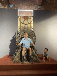 Tim and Max on the Iron Throne from Game of Thrones at the Game of Thrones exhibition at the Lokrum Visitor Center at the southeast side of the Benedictine Monastery of St. Mary