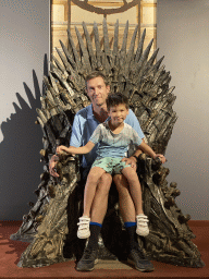 Tim and Max on the Iron Throne from Game of Thrones at the Game of Thrones exhibition at the Lokrum Visitor Center at the southeast side of the Benedictine Monastery of St. Mary