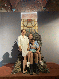 Tim, Miaomiao and Max on the Iron Throne from Game of Thrones at the Game of Thrones exhibition at the Lokrum Visitor Center at the southeast side of the Benedictine Monastery of St. Mary