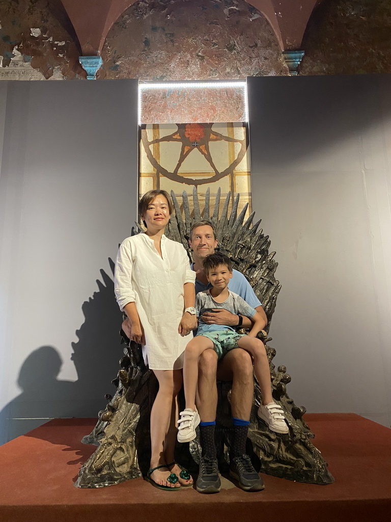 Tim, Miaomiao and Max on the Iron Throne from Game of Thrones at the Game of Thrones exhibition at the Lokrum Visitor Center at the southeast side of the Benedictine Monastery of St. Mary