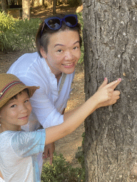 Miaomiao and Max with the skin of a Cicada on a tree