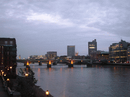 The Southwark Bridge over the Thames river, from the Millennium Bridge, by night