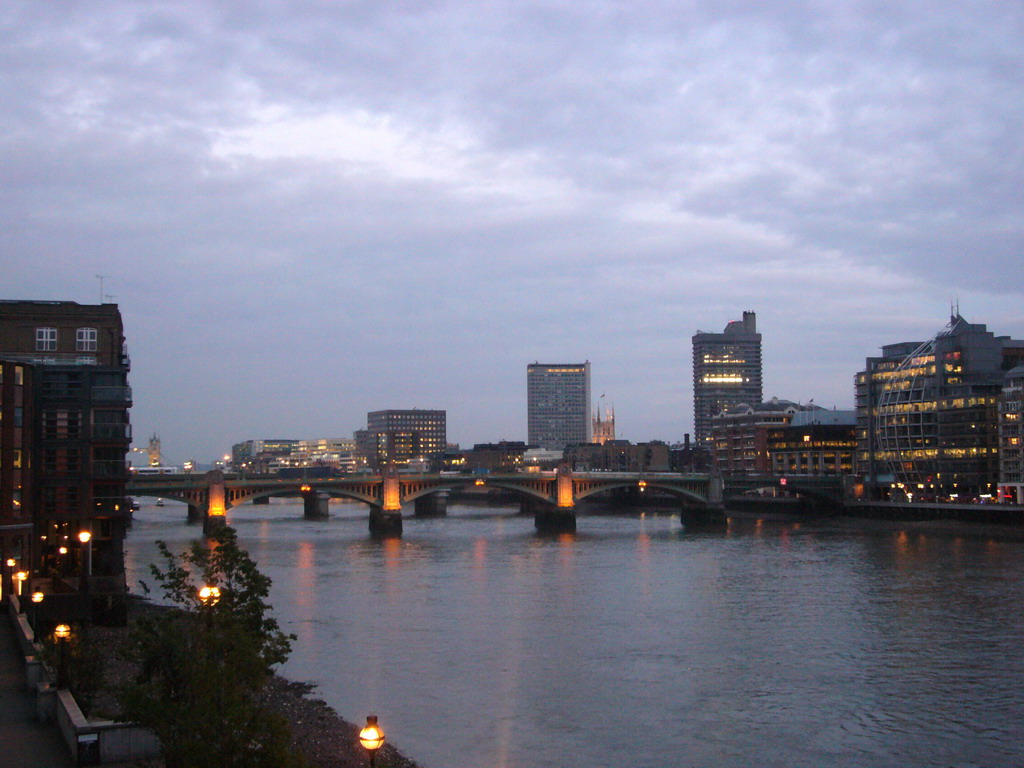 The Southwark Bridge over the Thames river, from the Millennium Bridge, by night