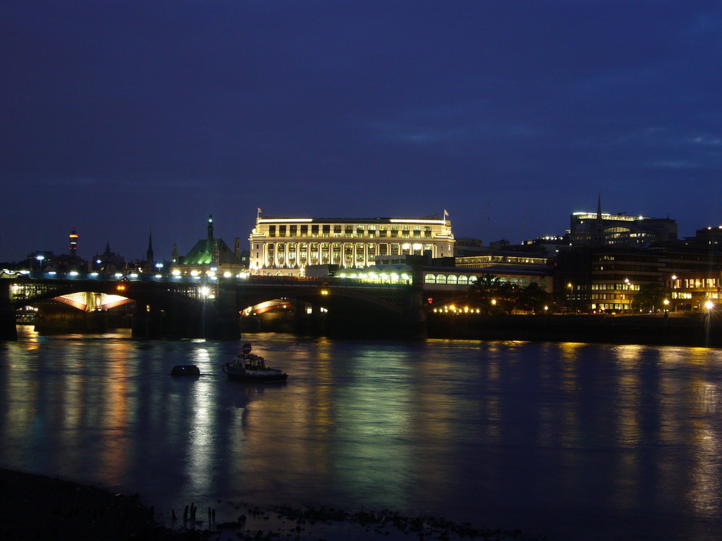 The Blackfriars Railway Bridge over the Thames river and the Unilever House, by night
