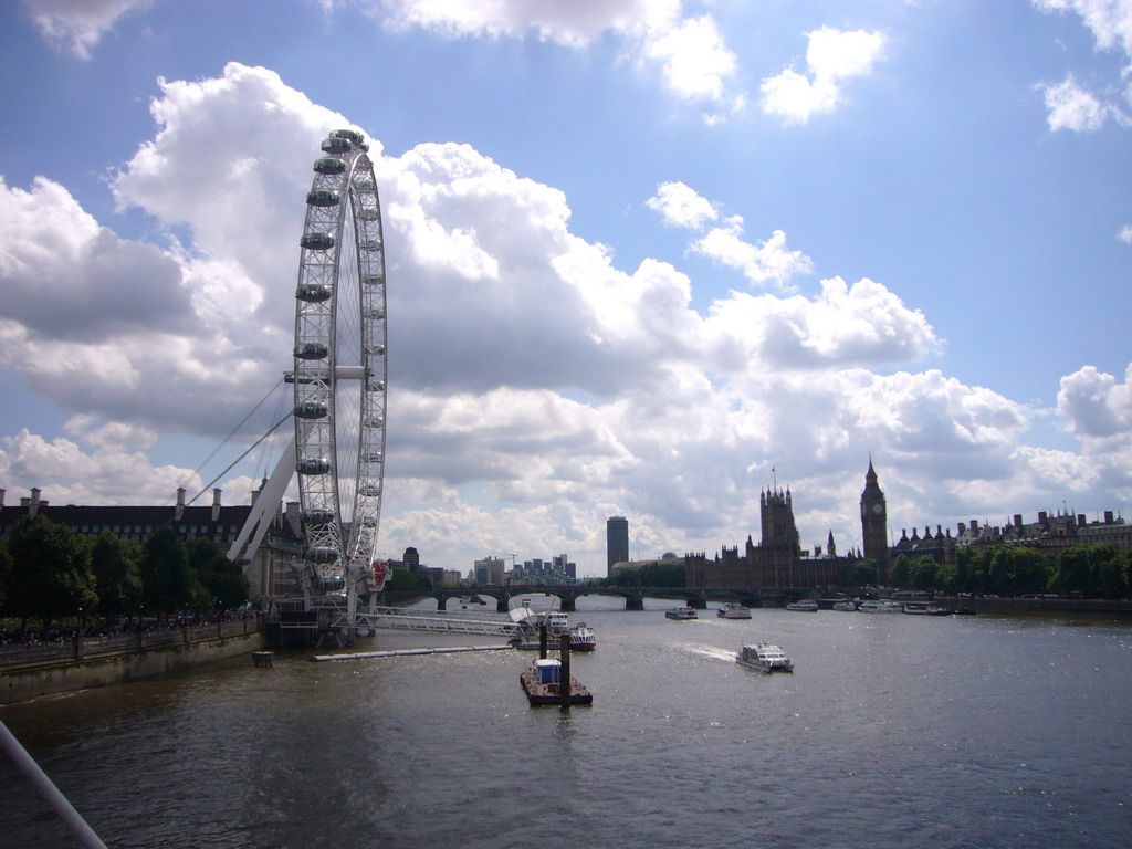 The London Eye, the Waterloo Millennium Pier, the Westminster Bridge over the Thames river and the Palace of Westminster with the Big Ben, from the Hungerford Bridge