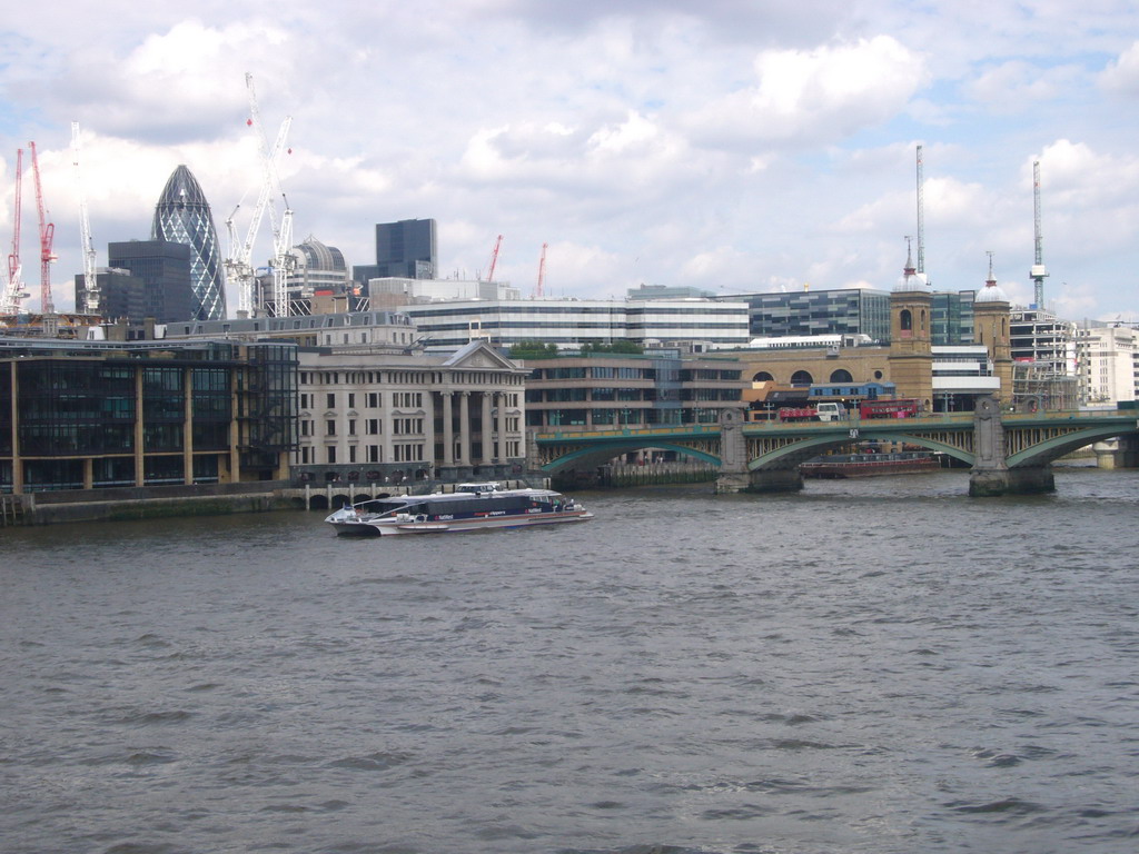 Cannon Street Station, 30 St. Mary Axe and the Southwark Bridge over the Thames river, from the Millennium Bridge