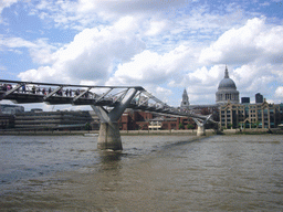 The Millennium Bridge over the Thames river, and St. Paul`s Cathedral