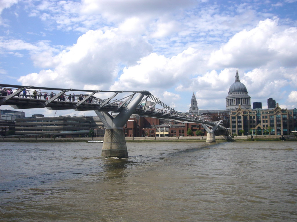 The Millennium Bridge over the Thames river, and St. Paul`s Cathedral