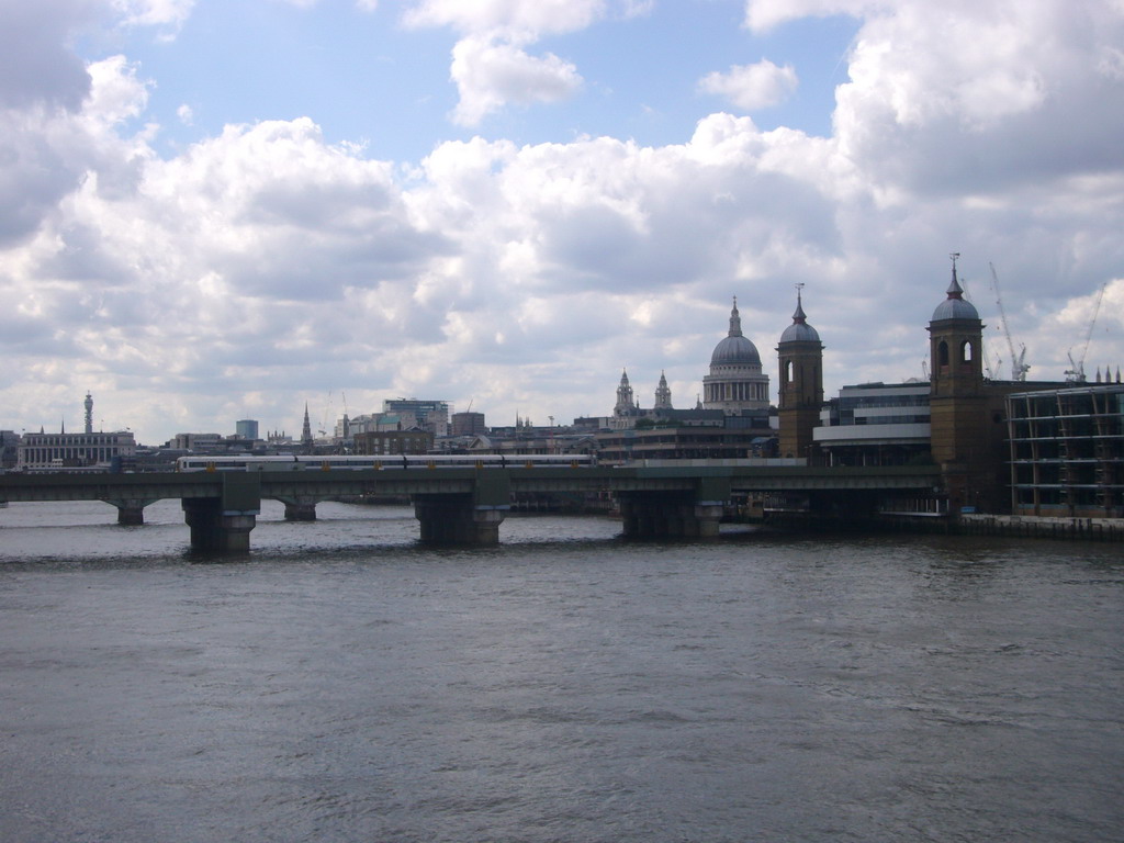 The Cannon Street Railway Bridge over the Thames river, the Cannon Street Station and St. Paul`s Cathedral, from London Bridge