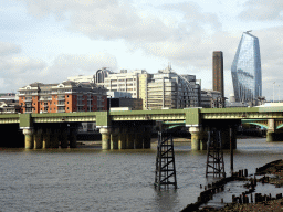 The Cannon Street Railway Bridge over the Thames river and the One Blackfriars Road building, viewed from below London Bridge