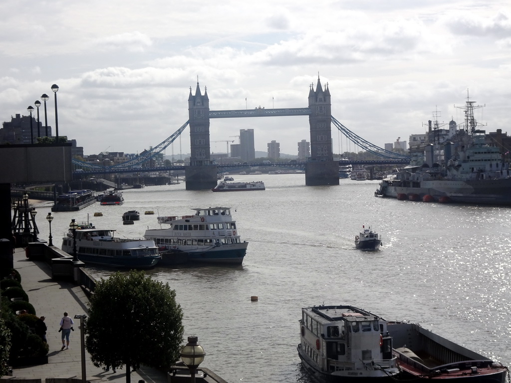 The HMS Belfast and other boats in the Thames river and the Tower Bridge, viewed from the staircase on the northeast side of London Bridge