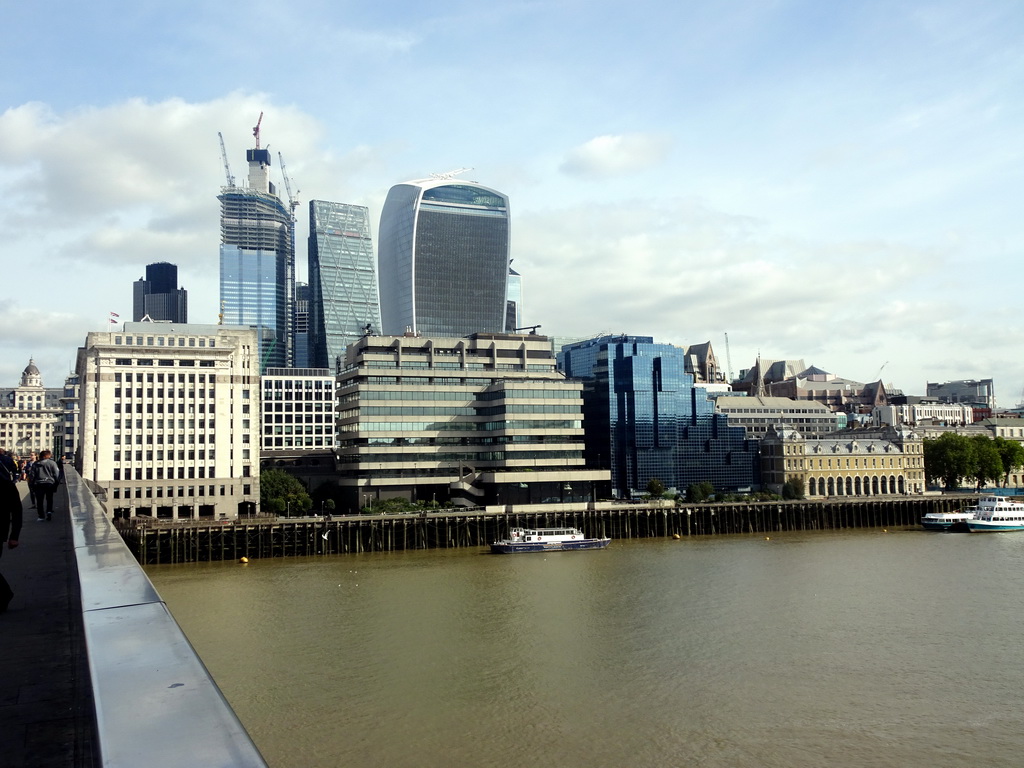 Boats in the Thames river, the House of Fraser, the 22 Bishopsgate building, under construction, the Leadenhall Building and the Sky Garden building, viewed from London Bridge