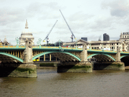 The Southwark Bridge over the Thames river and the towers and dome of St. Paul`s Cathedral, viewed from the Bankside