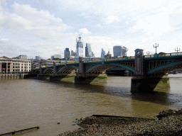 The Southwark Bridge over the Thames river, the 22 Bishopsgate building, under construction, the Leadenhall Building, the Scalpel building and the Sky Garden building, viewed from the Bankside