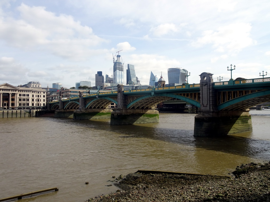 The Southwark Bridge over the Thames river, the 22 Bishopsgate building, under construction, the Leadenhall Building, the Scalpel building and the Sky Garden building, viewed from the Bankside