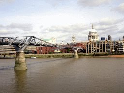 The Millennium Bridge over the Thames river and the towers and dome of St. Paul`s Cathedral, viewed from the Bankside