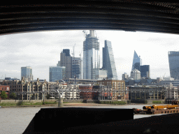 The Millennium Bridge over the Thames river, the 22 Bishopsgate building, under construction, the Leadenhall Building, the Scalpel building and the Sky Garden building, viewed from under the Blackfriars Railway Bridge