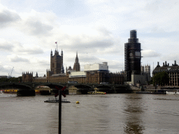 Boats in the Thames river, the Westminster Bridge and the Palace of Westminster with the Big Ben, under renovation, viewed from the Queen`s Walk