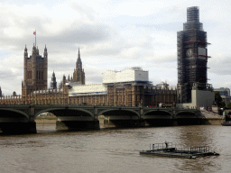 The Westminster Bridge over the Thames river and the Palace of Westminster with the Big Ben, under renovation, viewed from the Queen`s Walk