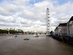 Boats in the Thames river, the Hungerford Bridge and Golden Jubilee Bridges, the Whitehall Gardens, the London Eye and the County Hall, viewed from the Westminster Bridge