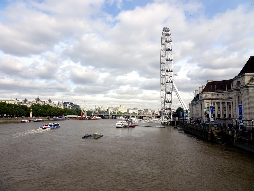 Boats in the Thames river, the Hungerford Bridge and Golden Jubilee Bridges, the Whitehall Gardens, the London Eye and the County Hall, viewed from the Westminster Bridge